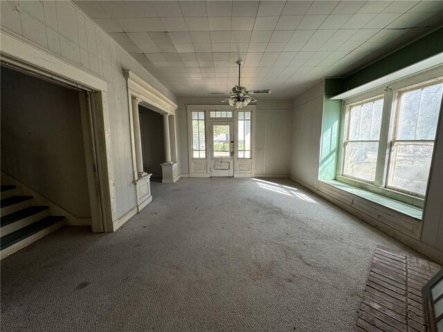 spare room with carpet flooring, plenty of natural light, and ceiling fan