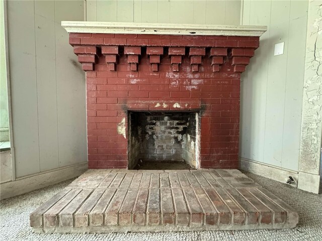 interior details with a brick fireplace