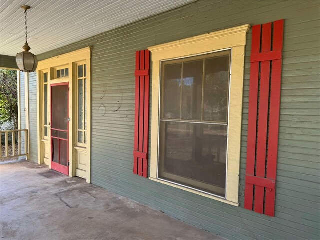 view of exterior entry with a porch