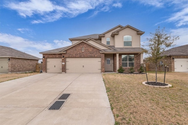 view of front of home with a front lawn, an attached garage, brick siding, and concrete driveway