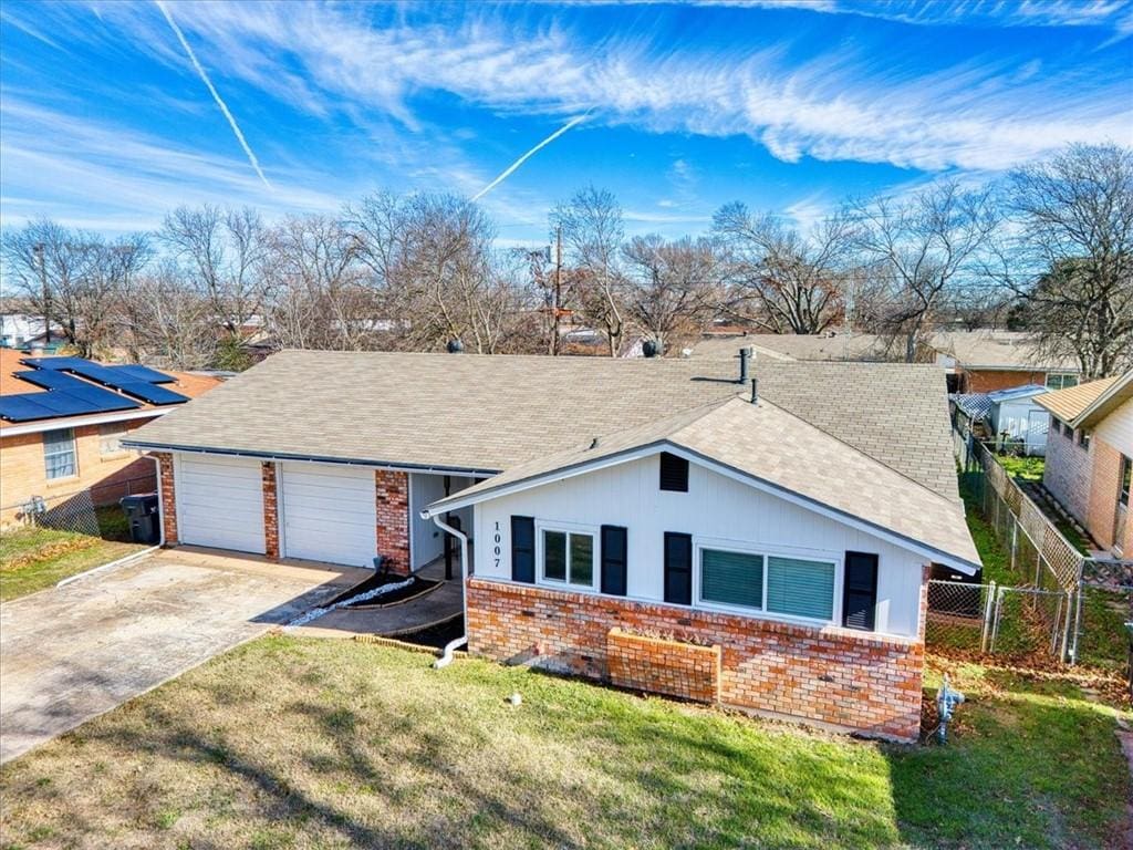 ranch-style house with a front lawn and a garage