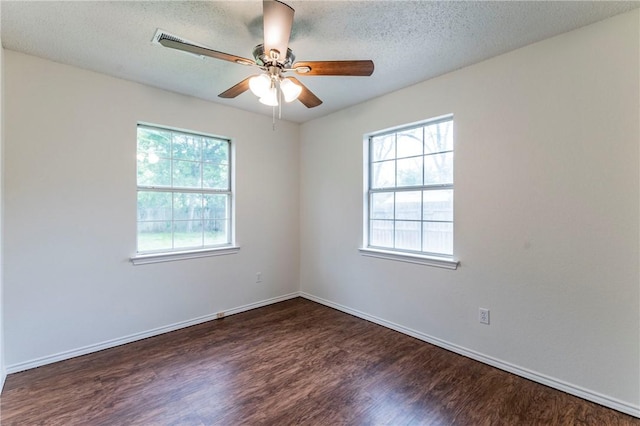 empty room with ceiling fan, dark hardwood / wood-style flooring, and a textured ceiling