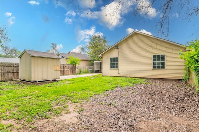 rear view of house with a yard and a storage shed