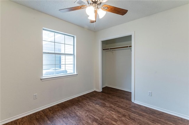 unfurnished bedroom with a textured ceiling, a closet, ceiling fan, and dark wood-type flooring