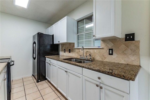 kitchen with white cabinets, dark stone countertops, sink, and black appliances