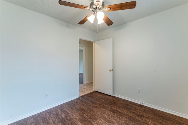 spare room with hardwood / wood-style floors and ceiling fan