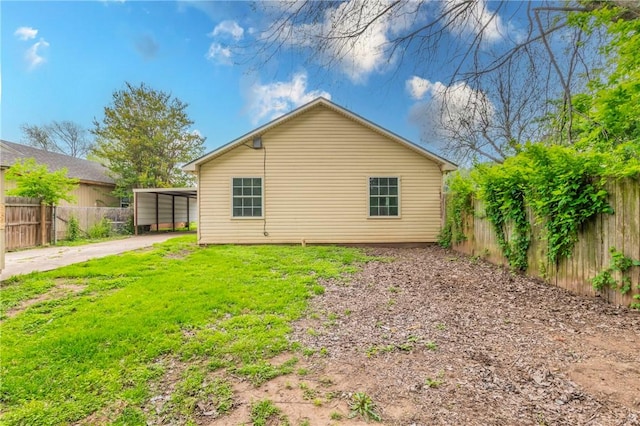 view of property exterior with a carport and a yard