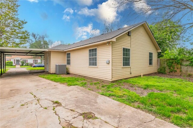 view of home's exterior with central AC unit and a carport