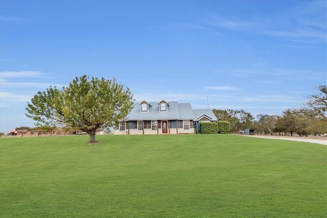 cape cod house with a front yard and a porch