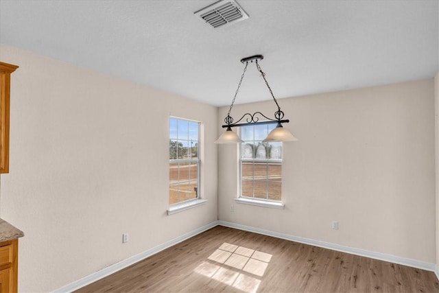 unfurnished dining area with wood-type flooring