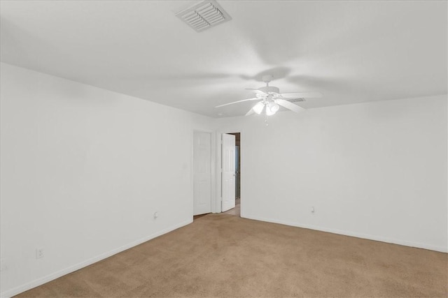 unfurnished room featuring ceiling fan and light carpet