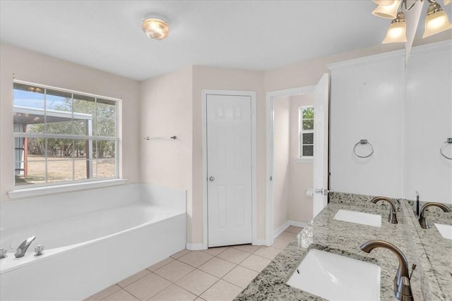 bathroom featuring tile patterned flooring, vanity, and a bathing tub