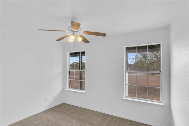 empty room featuring carpet floors and ceiling fan