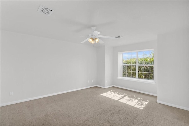 carpeted spare room with ceiling fan