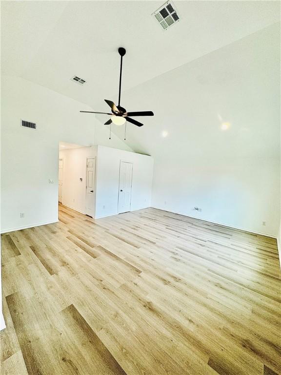 interior space featuring ceiling fan, light wood-type flooring, and high vaulted ceiling