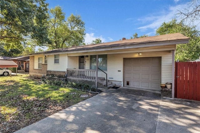 ranch-style house featuring a carport, a garage, and covered porch