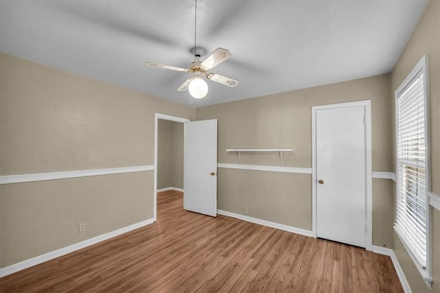 unfurnished bedroom featuring hardwood / wood-style floors and ceiling fan