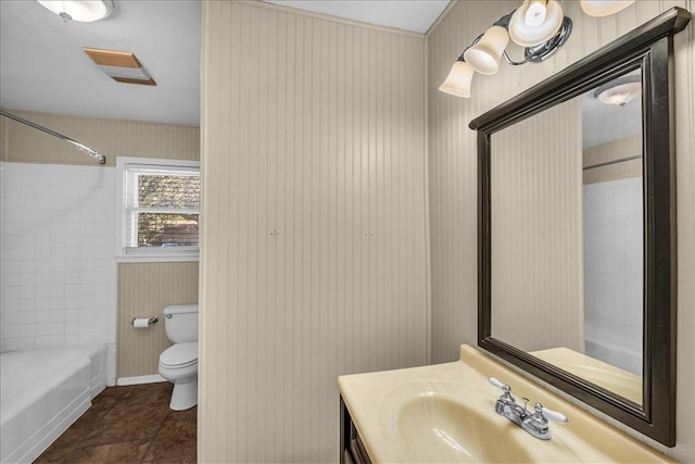 full bathroom with tile patterned flooring, vanity, tiled shower / bath combo, and toilet