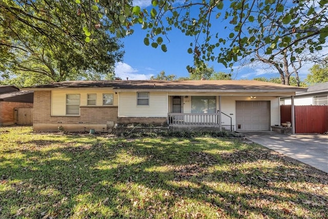 single story home featuring covered porch, a garage, and a front yard