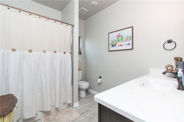 bathroom featuring vanity, hardwood / wood-style floors, and toilet