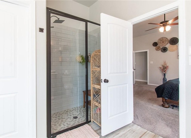 bathroom with an enclosed shower and ceiling fan