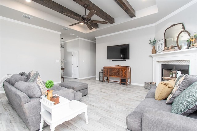 living room featuring crown molding, beam ceiling, light hardwood / wood-style flooring, and a raised ceiling