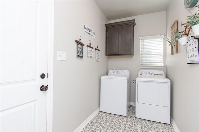 washroom with cabinets and washing machine and clothes dryer