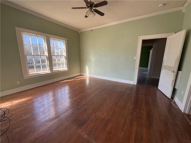 empty room with crown molding, ceiling fan, dark wood-type flooring, and a textured ceiling