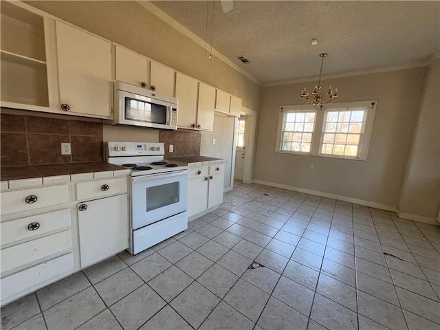 kitchen featuring white cabinetry, a textured ceiling, white appliances, and decorative backsplash