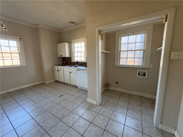 laundry area featuring sink, a textured ceiling, plenty of natural light, hookup for a washing machine, and electric dryer hookup