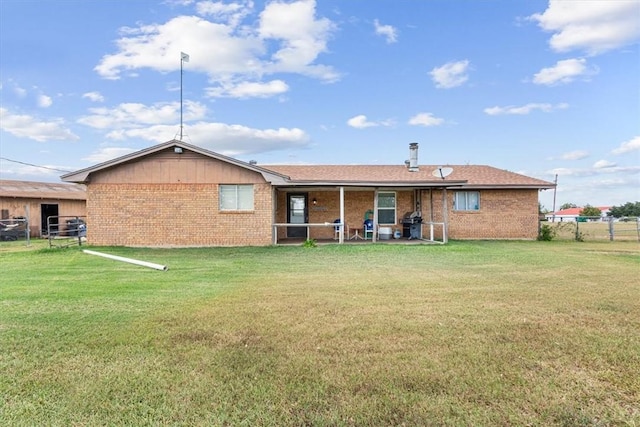 rear view of house featuring a yard