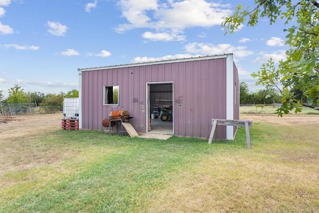 view of outbuilding with a lawn