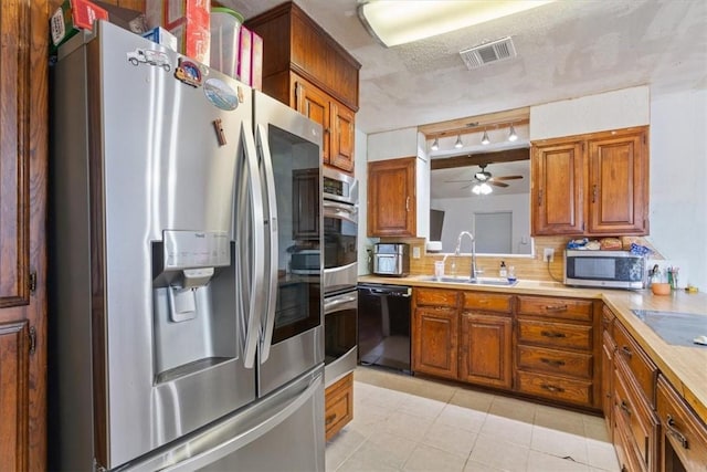 kitchen with decorative backsplash, ceiling fan, sink, black appliances, and light tile patterned floors