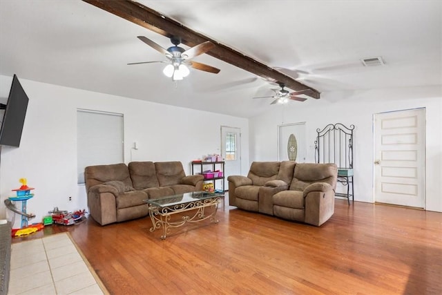 living room with hardwood / wood-style flooring and lofted ceiling with beams