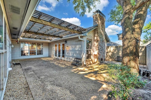 exterior space with a patio, fence, a chimney, and a pergola