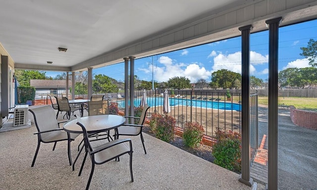 view of patio with outdoor dining area, a fenced in pool, and fence