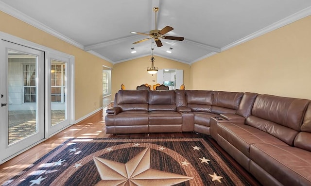 living room featuring lofted ceiling, wood finished floors, crown molding, baseboards, and ceiling fan