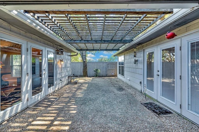 view of patio with french doors, a pergola, and fence