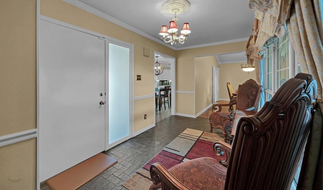 foyer entrance featuring a notable chandelier, baseboards, brick floor, and ornamental molding