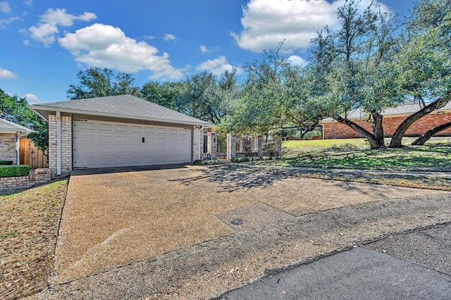 view of front of home with fence and a garage