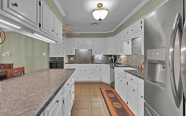 kitchen featuring visible vents, appliances with stainless steel finishes, ornamental molding, and decorative backsplash