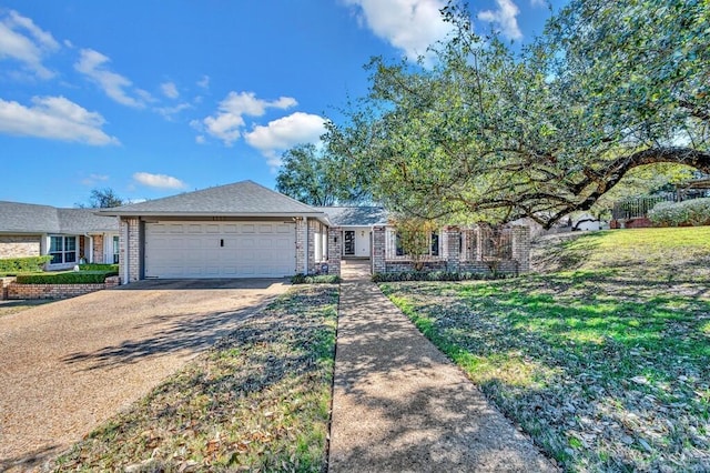 view of front facade featuring concrete driveway, an attached garage, and a front yard