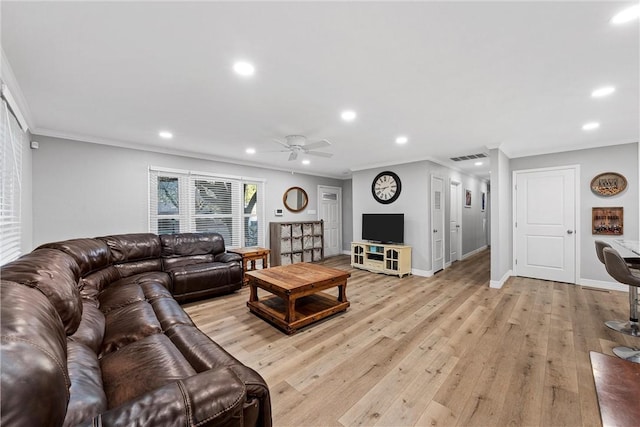 living room with light wood finished floors, crown molding, and recessed lighting