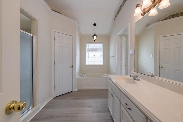 bathroom with lofted ceiling, separate shower and tub, wood-type flooring, and ornamental molding