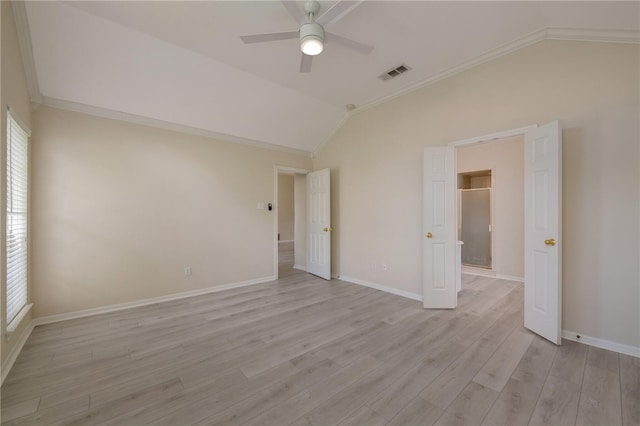 unfurnished room featuring ceiling fan, crown molding, light hardwood / wood-style flooring, and vaulted ceiling