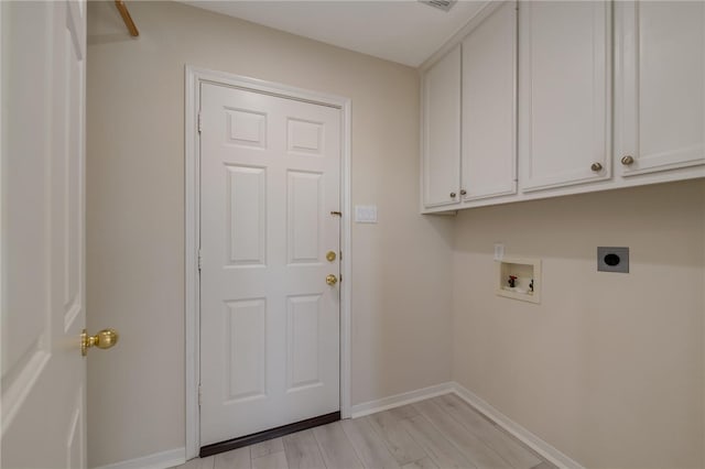 laundry room featuring hookup for an electric dryer, cabinets, light wood-type flooring, and hookup for a washing machine