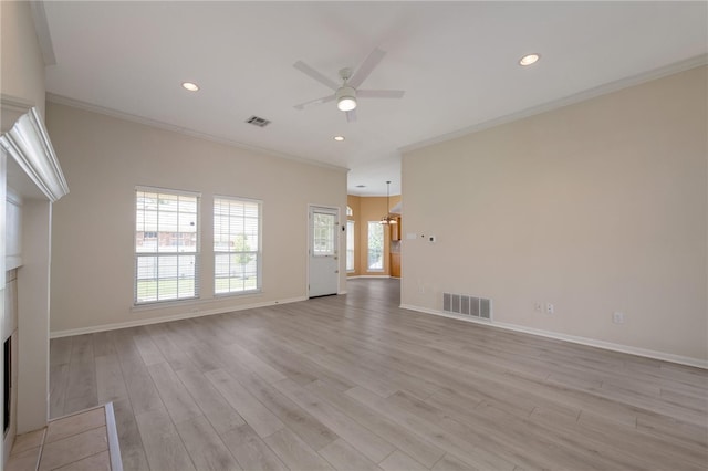 unfurnished living room with ceiling fan, ornamental molding, and light wood-type flooring