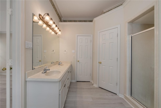 bathroom with crown molding, vanity, a shower with shower door, and hardwood / wood-style flooring