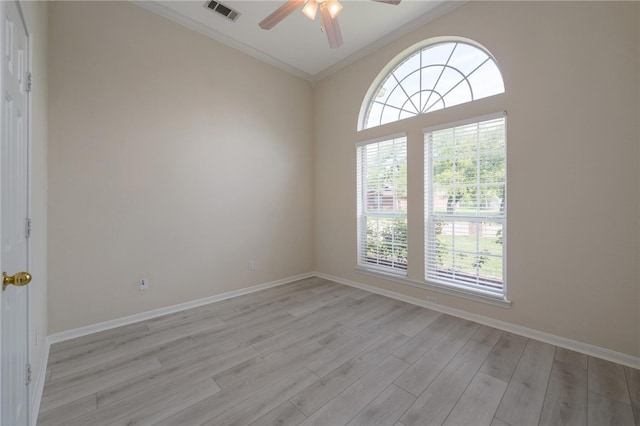 spare room with light wood-type flooring, ceiling fan, and crown molding