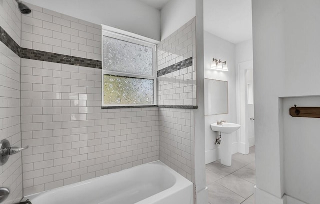 bathroom featuring tile patterned flooring and tiled shower / bath